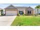 Charming single-story home with stone accents, a two-car garage, and a well-manicured lawn at 455 Hyacinth Loop, Murrells Inlet, SC 29576