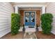 Charming home entrance featuring a decorative blue double front door with a welcoming wreath at 455 Hyacinth Loop, Murrells Inlet, SC 29576