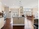 Spacious kitchen features island seating and stainless steel refrigerator adjacent to dining area at 455 Hyacinth Loop, Murrells Inlet, SC 29576