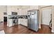 Well-lit kitchen features stainless steel appliances, granite countertops, and white cabinets at 455 Hyacinth Loop, Murrells Inlet, SC 29576