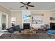 Open-concept living room with fireplace, built-in shelving, and an abundance of natural light at 455 Hyacinth Loop, Murrells Inlet, SC 29576