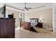 Bedroom boasts a trey ceiling, carpet floors, ceiling fan, and natural light from the windows at 455 Hyacinth Loop, Murrells Inlet, SC 29576