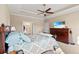 Carpeted bedroom features trey ceilings, fan, and an ensuite bath, and dark stained furniture at 455 Hyacinth Loop, Murrells Inlet, SC 29576