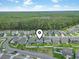 Aerial view of a residential area with well-kept homes and a large forest in the background at 4927 Sandlewood Dr., Myrtle Beach, SC 29579