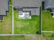 Aerial view of a backyard with a patio, dining area, lush green lawn, and privacy fence at 4927 Sandlewood Dr., Myrtle Beach, SC 29579