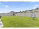Spacious, fenced backyard with lush green grass, a swing, and room to play at 4927 Sandlewood Dr., Myrtle Beach, SC 29579