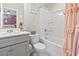 Well-lit bathroom featuring a shower-tub combination, vanity with sink, and white tile at 4927 Sandlewood Dr., Myrtle Beach, SC 29579