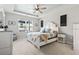 Inviting bedroom with tray ceiling, neutral colors, large windows, and carpeted floors at 4927 Sandlewood Dr., Myrtle Beach, SC 29579