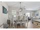 Dining room featuring a white table set for six, a modern chandelier, and hardwood flooring at 4927 Sandlewood Dr., Myrtle Beach, SC 29579