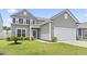 Charming two-story home with gray siding, manicured lawn, and attached two-car garage at 4927 Sandlewood Dr., Myrtle Beach, SC 29579