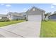 Exterior view of a well-maintained home with a concrete driveway, a white garage door, and green lawn at 4927 Sandlewood Dr., Myrtle Beach, SC 29579