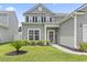 Charming two-story home with a landscaped front yard, well-maintained lawn, and a welcoming entrance at 4927 Sandlewood Dr., Myrtle Beach, SC 29579