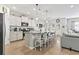 Bright kitchen with stainless steel appliances, a granite countertop island with barstool seating, and wood flooring at 4927 Sandlewood Dr., Myrtle Beach, SC 29579