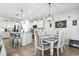Beautiful kitchen with stainless steel appliances, granite countertops, white cabinetry, island seating, and adjacent dining area at 4927 Sandlewood Dr., Myrtle Beach, SC 29579