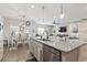 Open-concept kitchen features granite island, stainless sink, and seamless flow into dining and living areas at 4927 Sandlewood Dr., Myrtle Beach, SC 29579