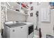 Efficient laundry room with modern Maytag machines, floating shelves, and stylish decor for a functional and organized space at 4927 Sandlewood Dr., Myrtle Beach, SC 29579