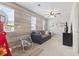 Cozy living room with wood accent wall, ceiling fan, and comfortable gray sofa at 4927 Sandlewood Dr., Myrtle Beach, SC 29579