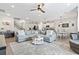 Open-concept living area with modern furnishings, kitchen view, hardwood floors, and abundant natural light at 4927 Sandlewood Dr., Myrtle Beach, SC 29579