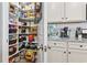 Organized walk-in pantry with shelving and easy access to the kitchen with granite counters at 4927 Sandlewood Dr., Myrtle Beach, SC 29579