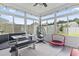 Bright sunroom with large windows, dining bench, egg chair, and outdoor view at 4927 Sandlewood Dr., Myrtle Beach, SC 29579