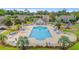 Aerial shot of community swimming pool with lounge chairs, umbrellas, and well-manicured landscaping at 503 20Th Ave. N # 55B, North Myrtle Beach, SC 29582