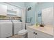 This laundry bathroom combo features a single vanity, toilet, and a modern washer and dryer at 503 20Th Ave. N # 55B, North Myrtle Beach, SC 29582