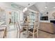 Dining area with backyard views, a round table, and sightlines into the adjacent living room at 503 20Th Ave. N # 55B, North Myrtle Beach, SC 29582