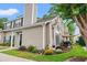 Charming townhouse with tan siding, a chimney, and landscaping with colorful flowers and shrubbery at 503 20Th Ave. N # 55B, North Myrtle Beach, SC 29582