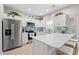 Modern kitchen featuring white cabinetry, a stainless steel refrigerator, and a breakfast bar for seating at 503 20Th Ave. N # 55B, North Myrtle Beach, SC 29582