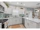 Bright kitchen with white cabinets, light countertops, stainless steel appliances, and backyard access at 503 20Th Ave. N # 55B, North Myrtle Beach, SC 29582