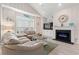 Comfortable living room with vaulted ceilings, light flooring, a fireplace, and large bright windows at 503 20Th Ave. N # 55B, North Myrtle Beach, SC 29582