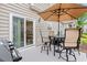 This outdoor patio features a table and chairs with an umbrella, as well as a grill at 503 20Th Ave. N # 55B, North Myrtle Beach, SC 29582
