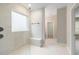 A spacious bathroom featuring a glass shower with marble-like tile and a bench at 5031 Vinesia Dr., Myrtle Beach, SC 29579