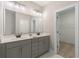 Bathroom with double sinks, gray cabinets, and a walk-in closet at 5031 Vinesia Dr., Myrtle Beach, SC 29579
