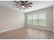 Bright empty bedroom with a large window offering outdoor views and modern vinyl flooring at 5031 Vinesia Dr., Myrtle Beach, SC 29579