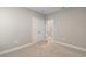 A bright, empty bedroom is illuminated by a large double door and modern carpet flooring at 5031 Vinesia Dr., Myrtle Beach, SC 29579