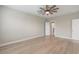 A bright, empty bedroom is illuminated by a rustic ceiling fan and modern vinyl flooring at 5031 Vinesia Dr., Myrtle Beach, SC 29579