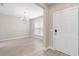 Inviting entryway featuring light wood flooring, a chandelier, and a modern white front door at 5031 Vinesia Dr., Myrtle Beach, SC 29579