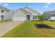 Well-maintained single-story home with a green lawn and a two-car garage at 5031 Vinesia Dr., Myrtle Beach, SC 29579