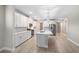 Spacious kitchen features white cabinets, stainless steel appliances, an island, and modern pendant lighting at 5031 Vinesia Dr., Myrtle Beach, SC 29579