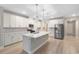 Bright, open kitchen with a large island, stainless steel appliances, and modern lighting at 5031 Vinesia Dr., Myrtle Beach, SC 29579