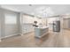 Modern kitchen with white cabinets, an island, stainless steel appliances, and sleek pendant lighting fixtures at 5031 Vinesia Dr., Myrtle Beach, SC 29579