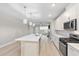 Modern kitchen boasts stainless appliances, an island with sink, and views into the living area at 5031 Vinesia Dr., Myrtle Beach, SC 29579