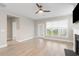 Cozy living room with light wood floors, a modern ceiling fan, and a fireplace creating a warm ambiance at 5031 Vinesia Dr., Myrtle Beach, SC 29579