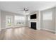 Spacious living room with light wood floors, a fireplace, and a ceiling fan, ideal for comfortable living at 5031 Vinesia Dr., Myrtle Beach, SC 29579