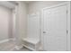 Practical mudroom featuring a built-in bench with hooks and storage, next to the door and light wood flooring at 5031 Vinesia Dr., Myrtle Beach, SC 29579