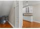 Cozy attic space with hardwood flooring, water heater and wet bar area with white cabinets and granite counters at 505 Beaty St., Conway, SC 29526