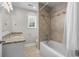 Bright bathroom with tub shower combo, vanity with granite countertops, and white cabinets at 505 Beaty St., Conway, SC 29526