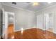 An airy bedroom is enhanced with hardwood floors, ensuite bath and walk-in closet at 505 Beaty St., Conway, SC 29526