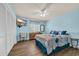 Light blue bedroom with hardwood floors, a ceiling fan, and a TV mounted on the wall at 510 Fairwood Lakes Dr. # 923G, Myrtle Beach, SC 29588